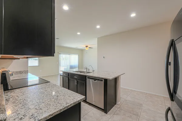 a kitchen with stainless steel appliances granite countertop a sink and a stove
