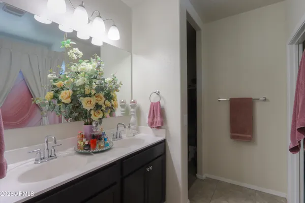 a bathroom with a sink a large mirror and a shower