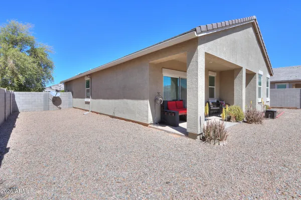 a view of a house with backyard and sitting area