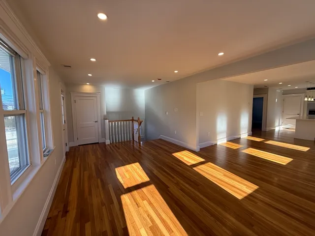 a view of kitchen with wooden floor and seating space