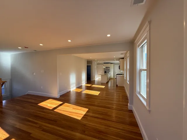 a view of a living room and wooden floor