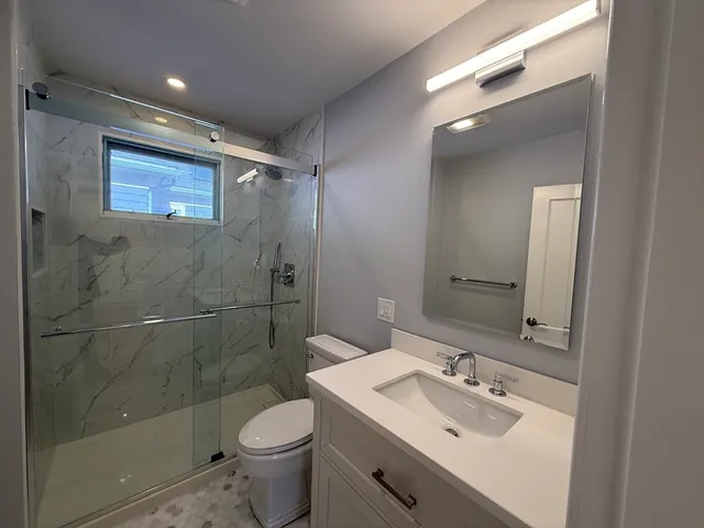 a bathroom with a sink toilet and shower