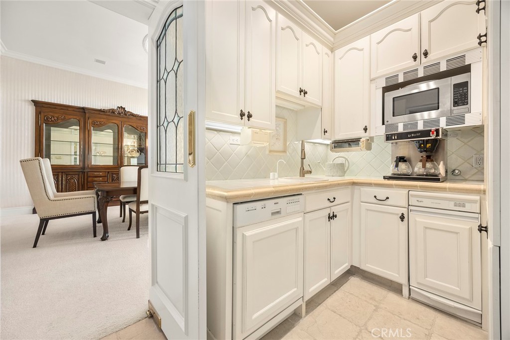 2112 Indian Creek Road Diamond Bar, CA 91765 - Photo 14 of 72 a kitchen with stainless steel appliances white cabinets and a refrigerator