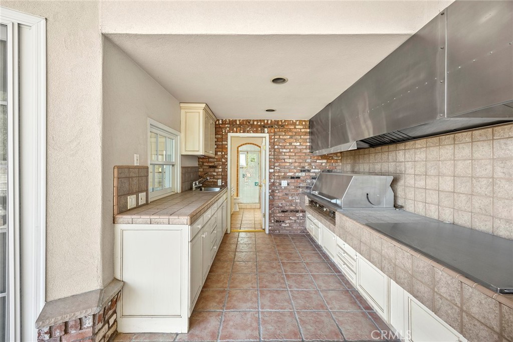 2112 Indian Creek Road Diamond Bar, CA 91765 - Photo 40 of 72 a kitchen with stainless steel appliances granite countertop a sink and a refrigerator