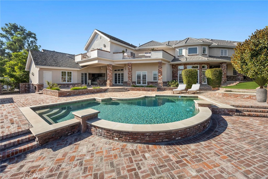 2112 Indian Creek Road Diamond Bar, CA 91765 - Photo 46 of 72 a view of a white house with a swimming pool and porch