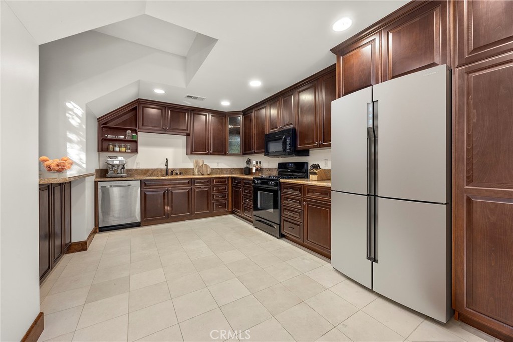 2112 Indian Creek Road Diamond Bar, CA 91765 - Photo 57 of 72 a kitchen with stainless steel appliances granite countertop a refrigerator sink and cabinets