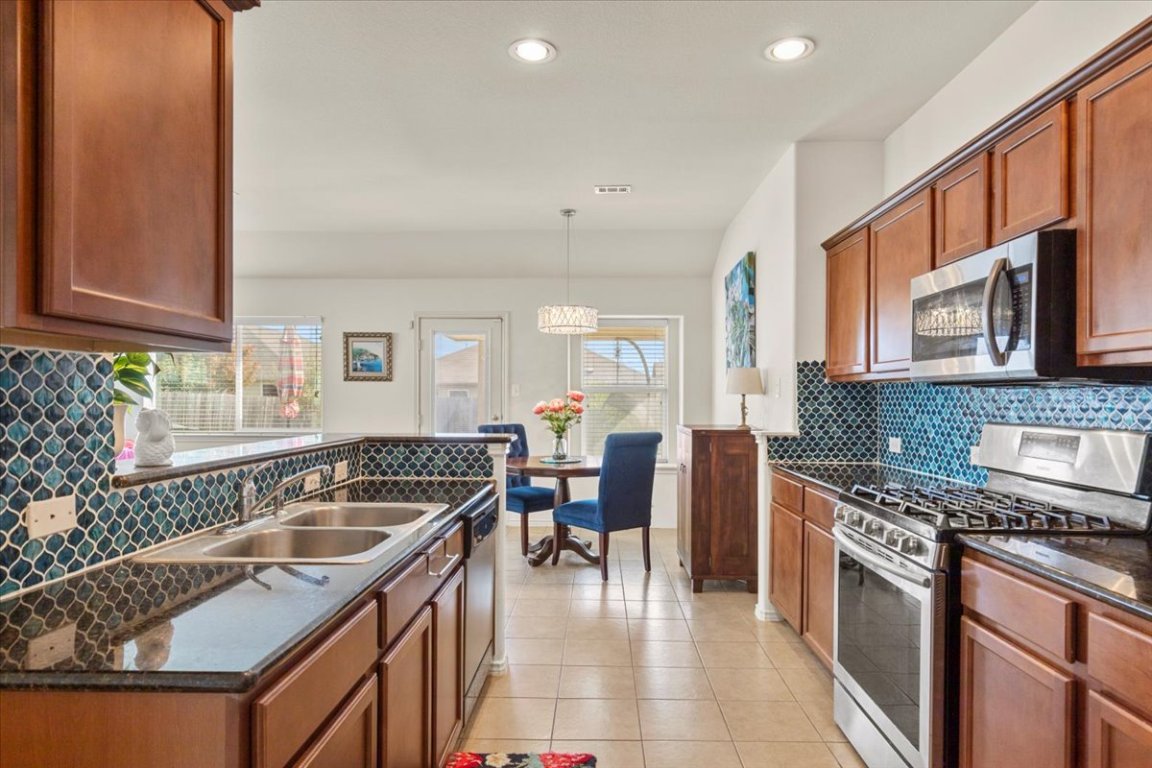 12500 Timber Heights Drive Austin, TX 78754 - Photo 11 of 31 a kitchen with granite countertop a sink and cabinets