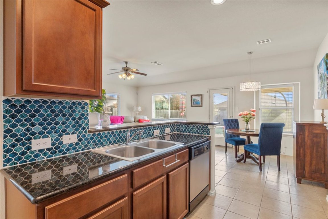 12500 Timber Heights Drive Austin, TX 78754 - Photo 12 of 31 a kitchen that has a sink and a chair in it