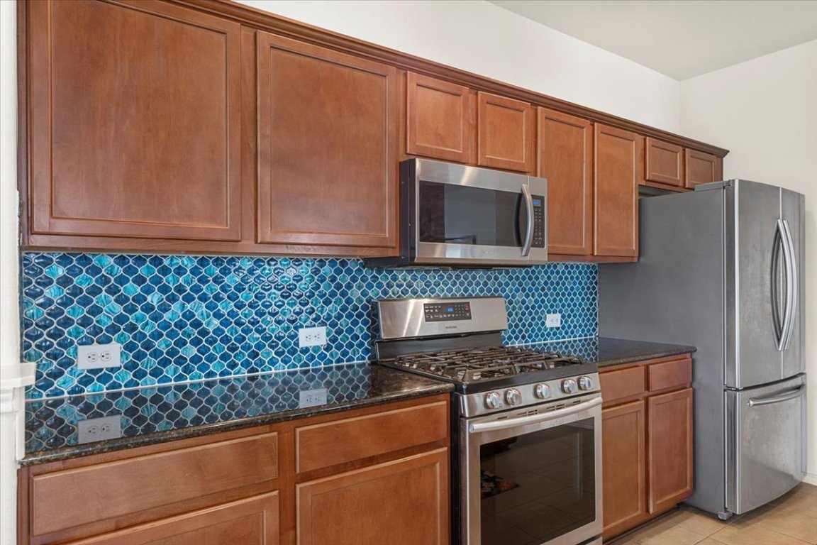 12500 Timber Heights Drive Austin, TX 78754 - Photo 14 of 31 a kitchen with stainless steel appliances granite countertop a refrigerator stove and microwave