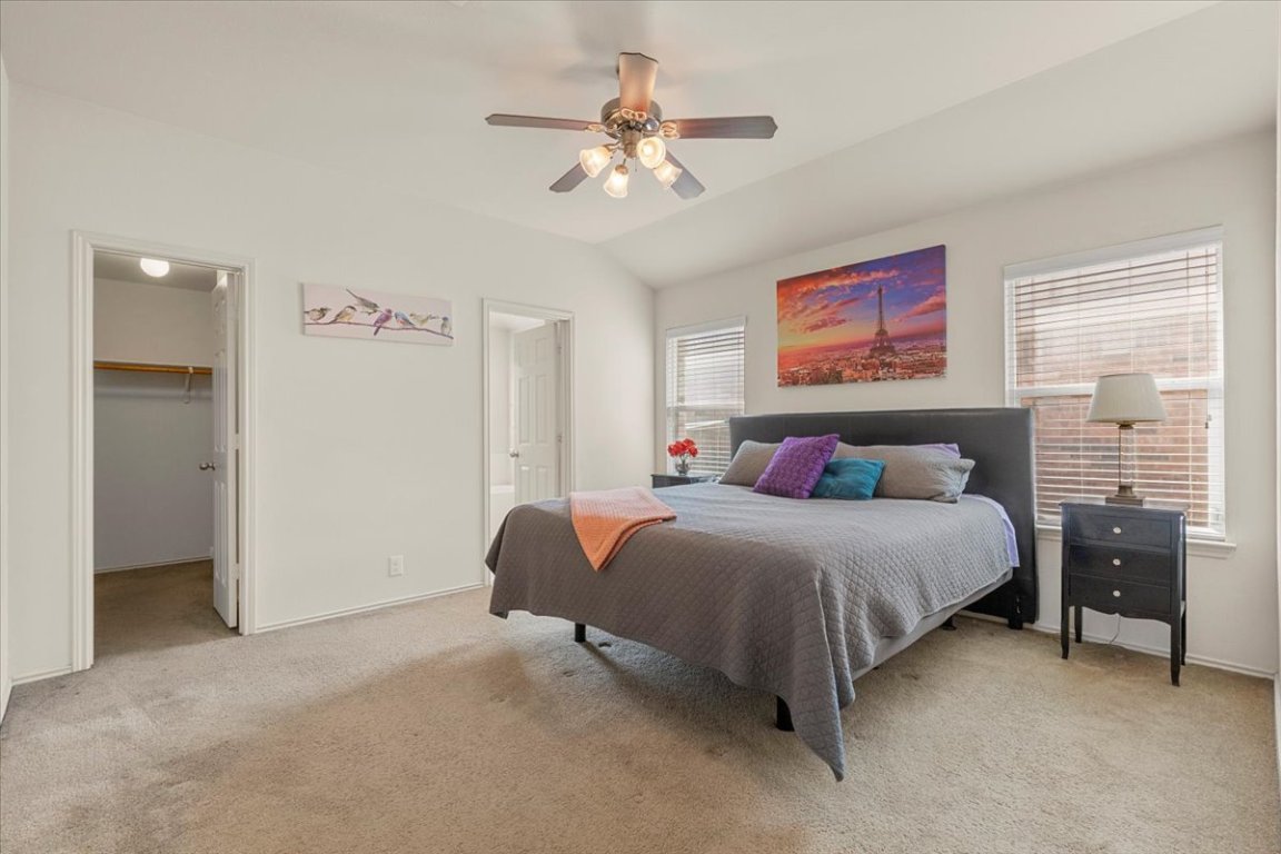 12500 Timber Heights Drive Austin, TX 78754 - Photo 16 of 31 a bedroom with a bed and ceiling fan