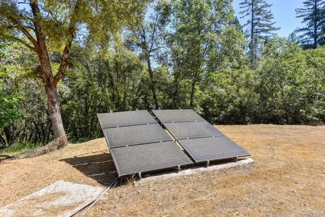 a backyard of a house with yard and trampoline
