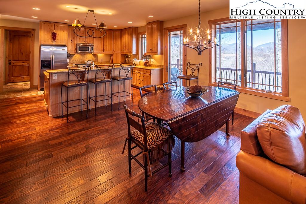 612 Bear Cubs Trail Boone, NC 28607 - Photo 11 of 37 a view of a dining room with furniture window and wooden floor