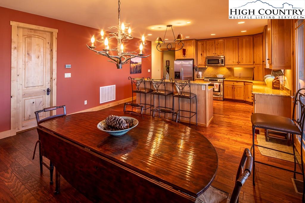 612 Bear Cubs Trail Boone, NC 28607 - Photo 13 of 37 a kitchen with stainless steel appliances dining table and chairs