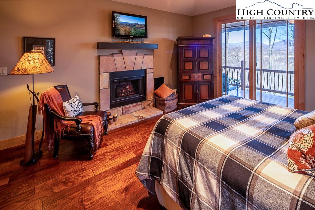 612 Bear Cubs Trail Boone, NC 28607 - Photo 17 of 37 a bedroom with a bed and a fireplace