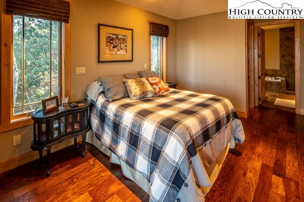 612 Bear Cubs Trail Boone, NC 28607 - Photo 19 of 37 a bedroom with a bed and wooden floor