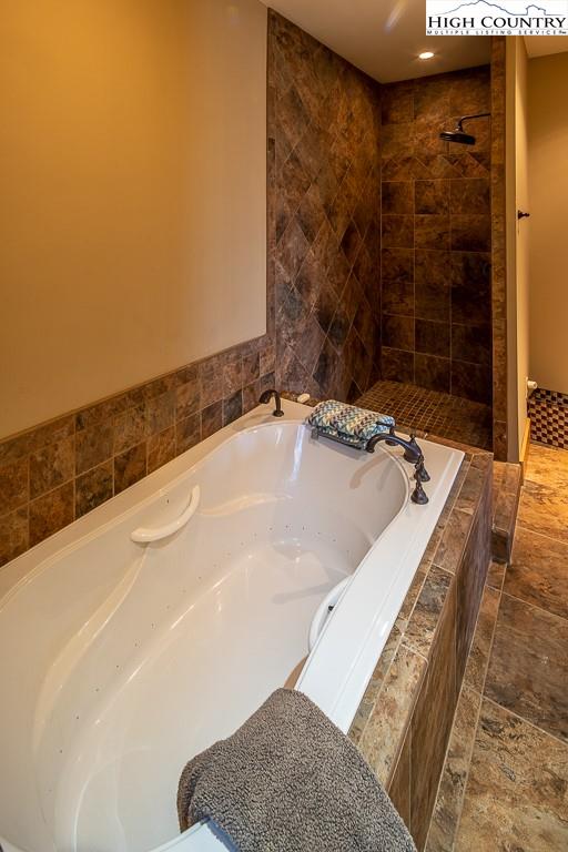 612 Bear Cubs Trail Boone, NC 28607 - Photo 22 of 37 a bathroom with a tub and shower