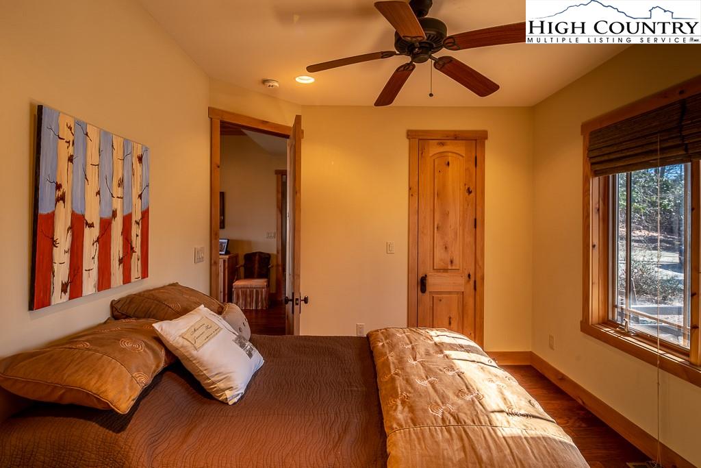 612 Bear Cubs Trail Boone, NC 28607 - Photo 24 of 37 a bedroom with a bed and a chandelier