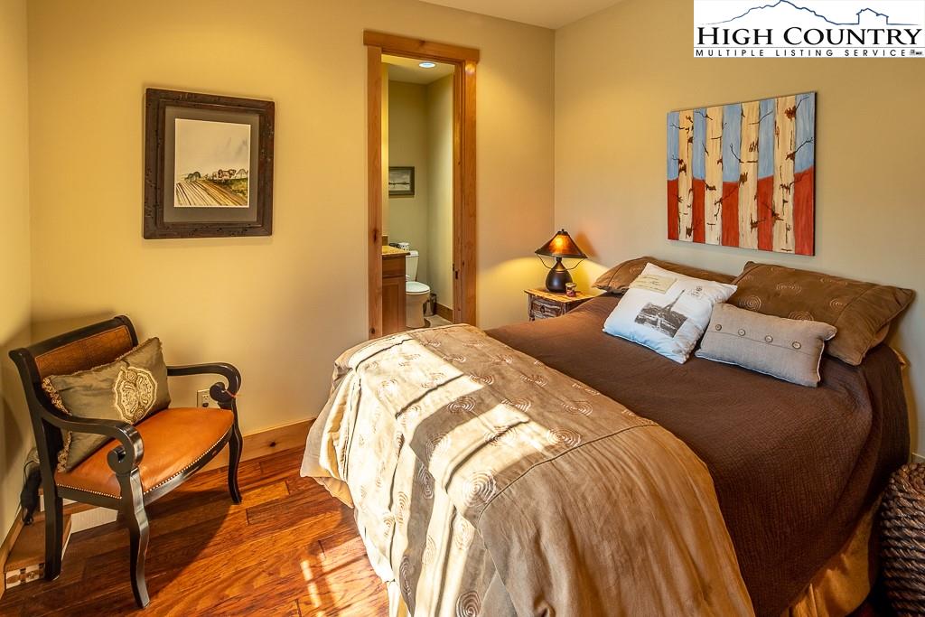 612 Bear Cubs Trail Boone, NC 28607 - Photo 25 of 37 a bed sitting in a bedroom next to a small yard