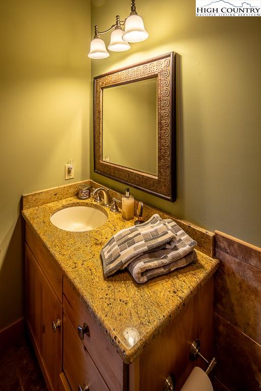 612 Bear Cubs Trail Boone, NC 28607 - Photo 31 of 37 a bathroom with a granite countertop sink and a mirror