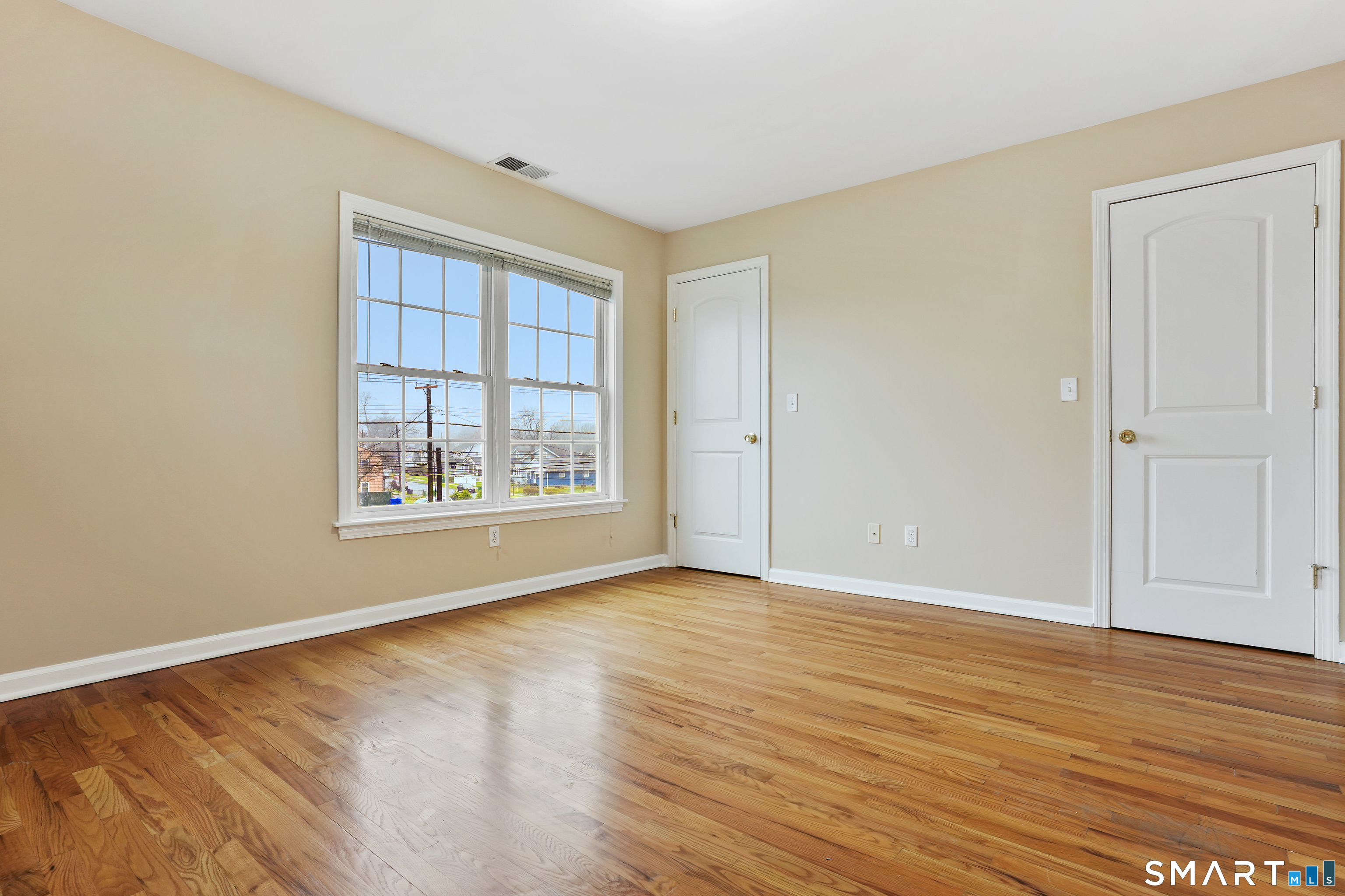 1180 Main Street Stratford, CT 06615 - Photo 11 of 22 a view of an empty room with wooden floor and a window