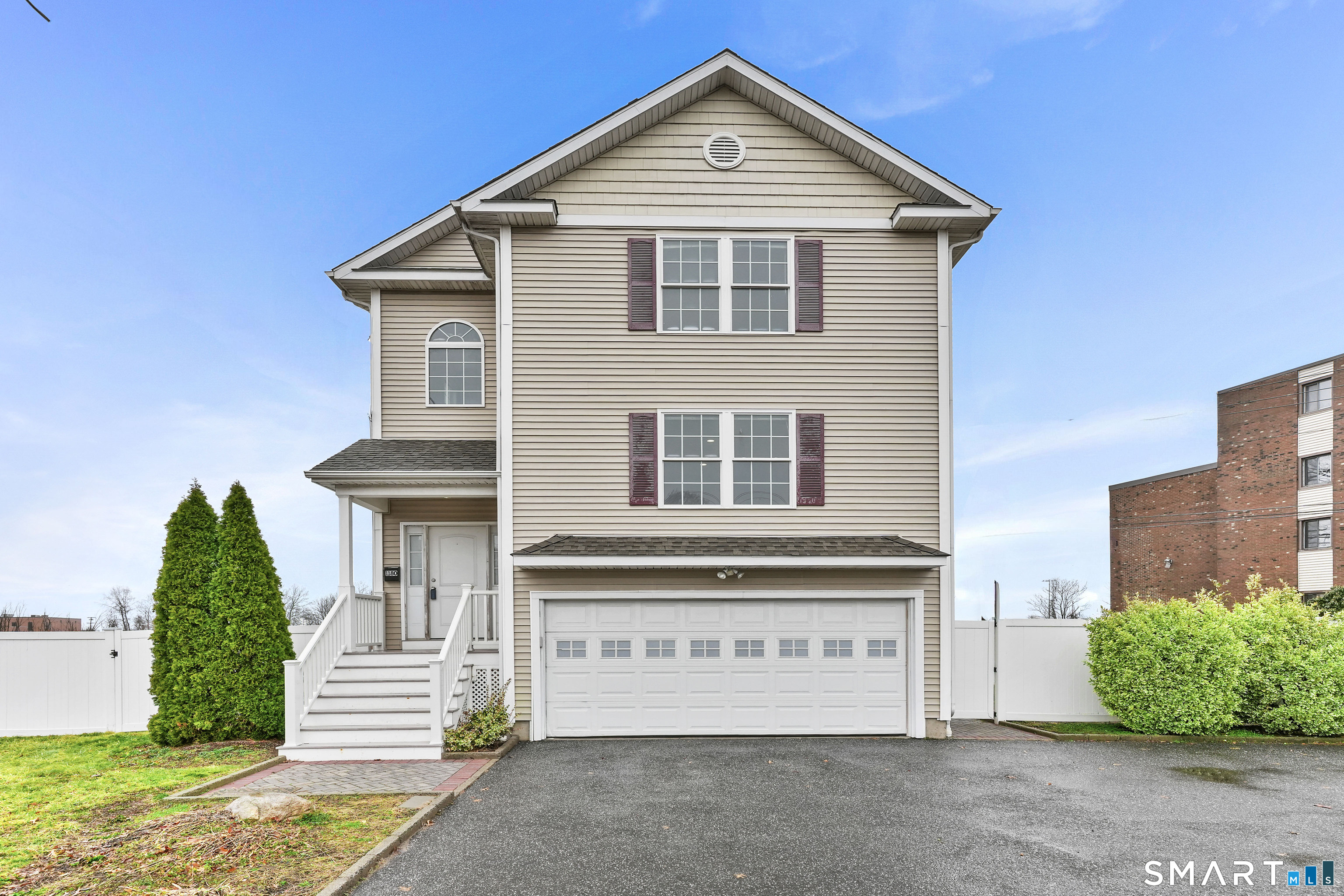 1180 Main Street Stratford, CT 06615 - Photo 2 of 22 a front view of a house with a yard