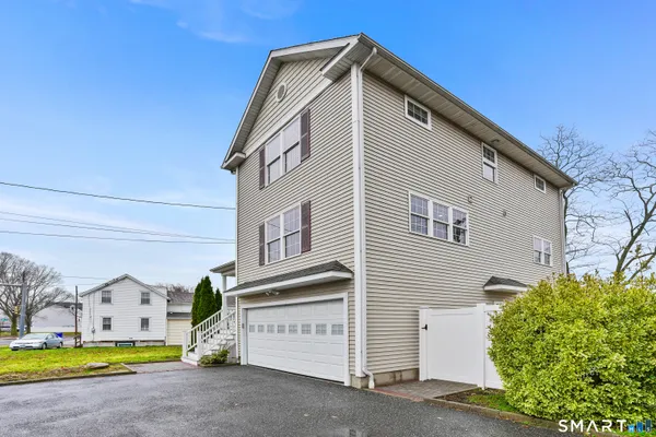 a view of a house with a yard and garage