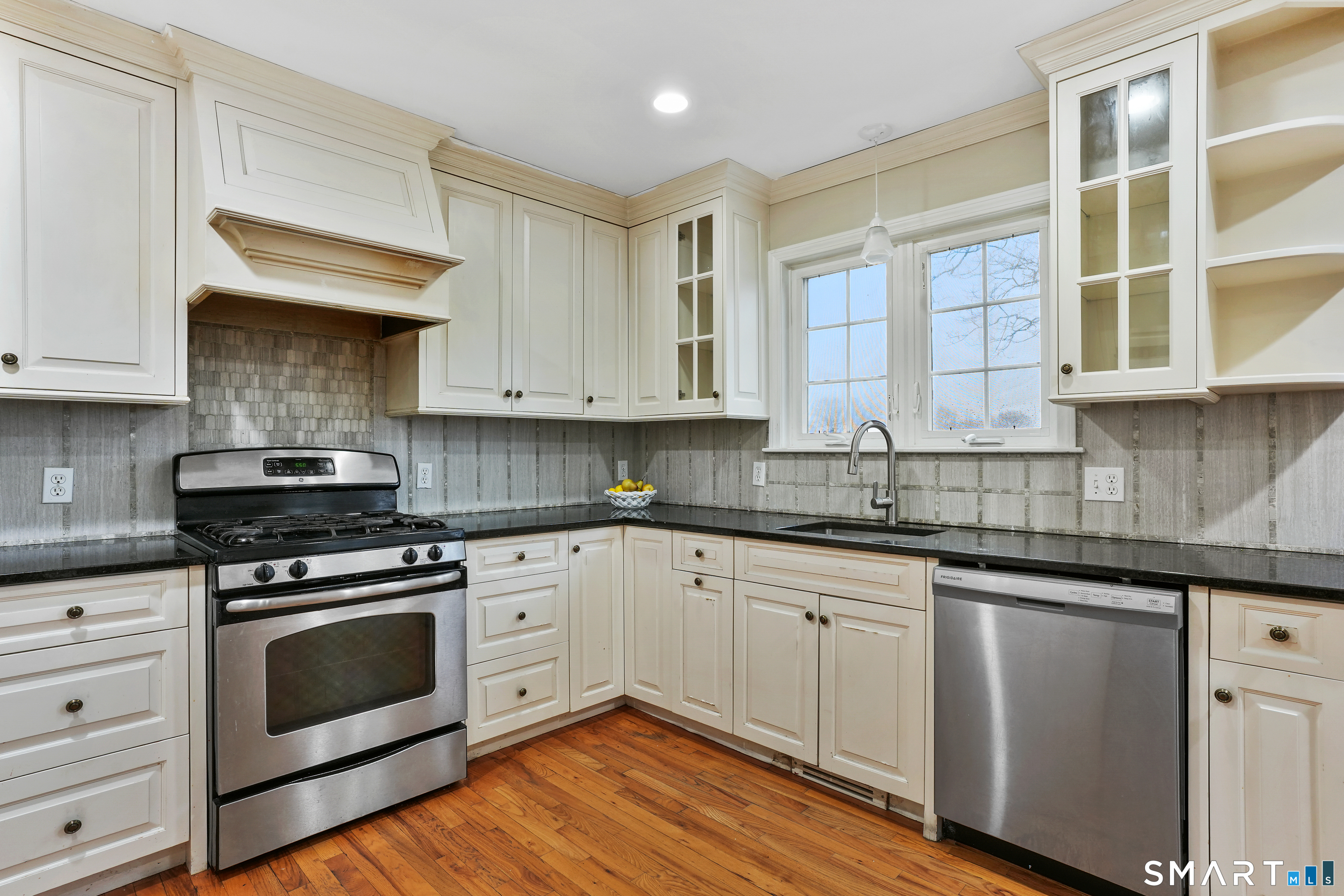 1180 Main Street Stratford, CT 06615 - Photo 5 of 22 a kitchen with stainless steel appliances granite countertop a stove and a sink
