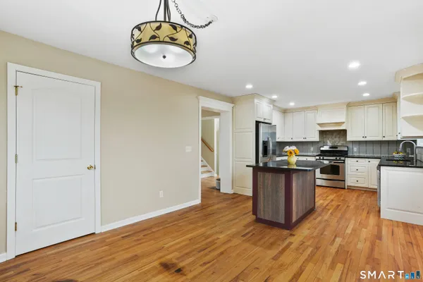 a kitchen with a refrigerator and microwave