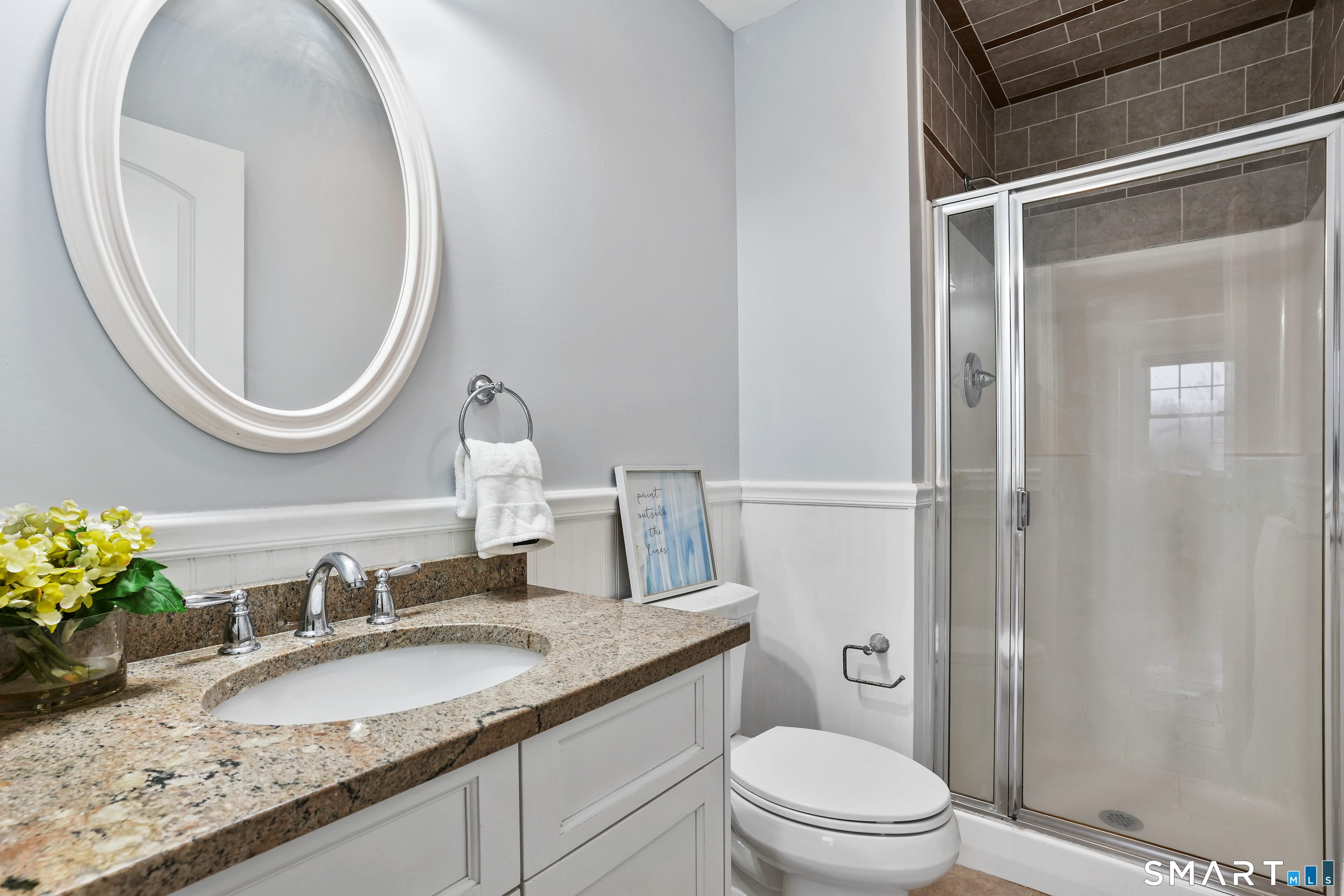 1180 Main Street Stratford, CT 06615 - Photo 8 of 22 a bathroom with a granite countertop toilet a sink and a mirror