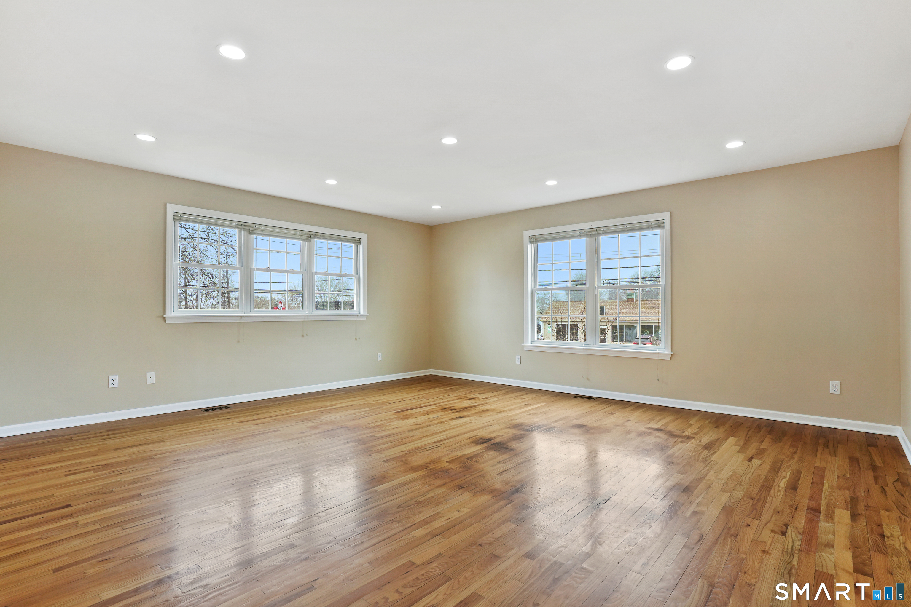 1180 Main Street Stratford, CT 06615 - Photo 10 of 22 a view of an empty room with wooden floor and a window
