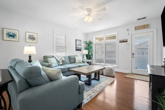 a living room with furniture wooden floor and a table