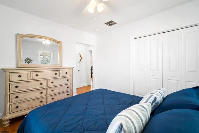 a bedroom with a bed and a dresser