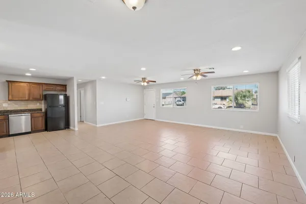 an empty room with windows and entrance