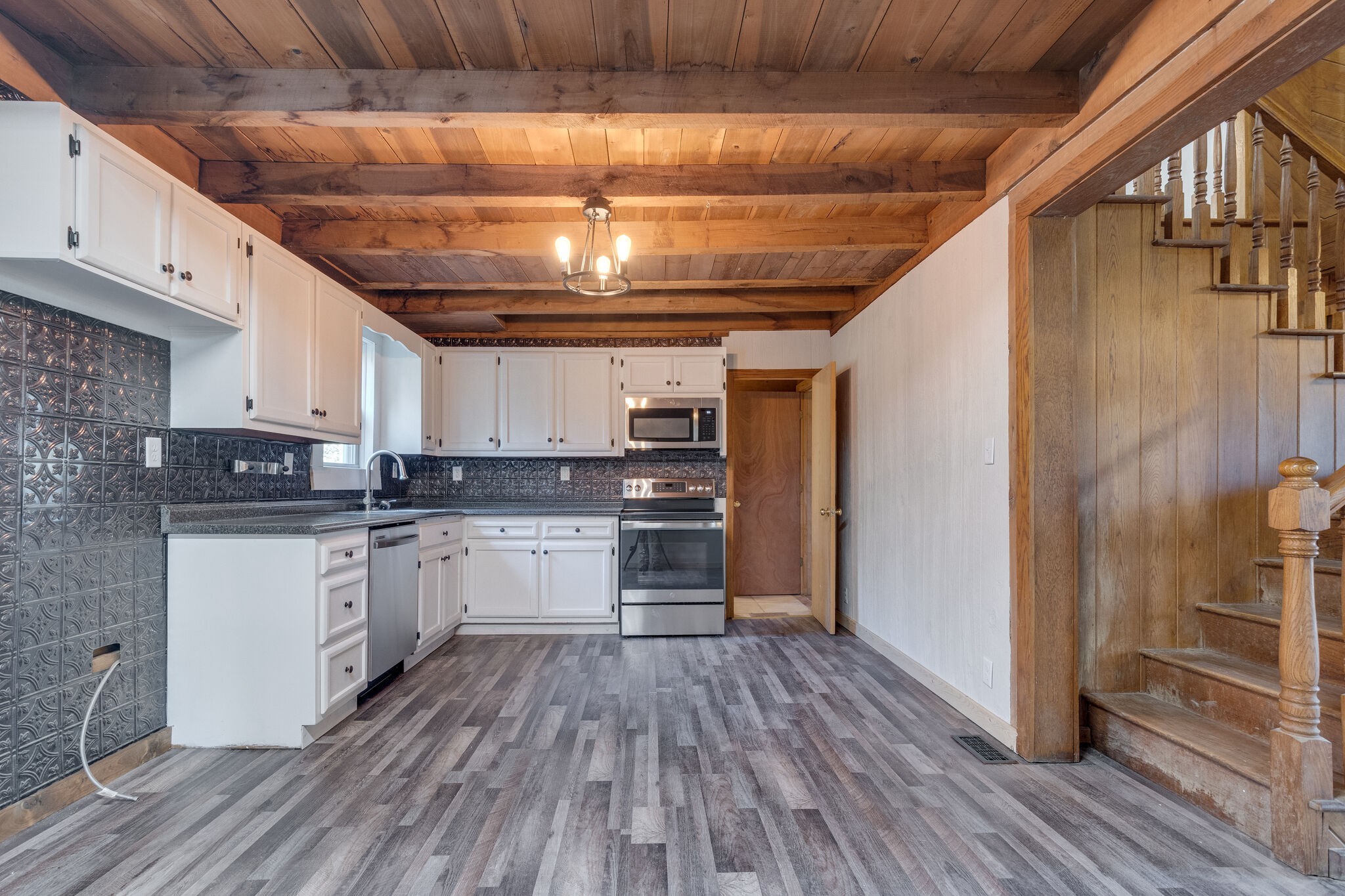 409 Elora Road Elora, TN 37328 - Photo 12 of 25 a kitchen with granite countertop wooden floors stainless steel appliances and counter space