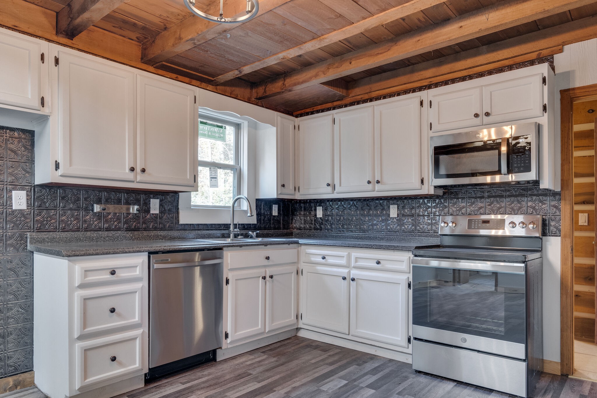 409 Elora Road Elora, TN 37328 - Photo 13 of 25 a kitchen with stainless steel appliances granite countertop a stove a sink and white cabinets
