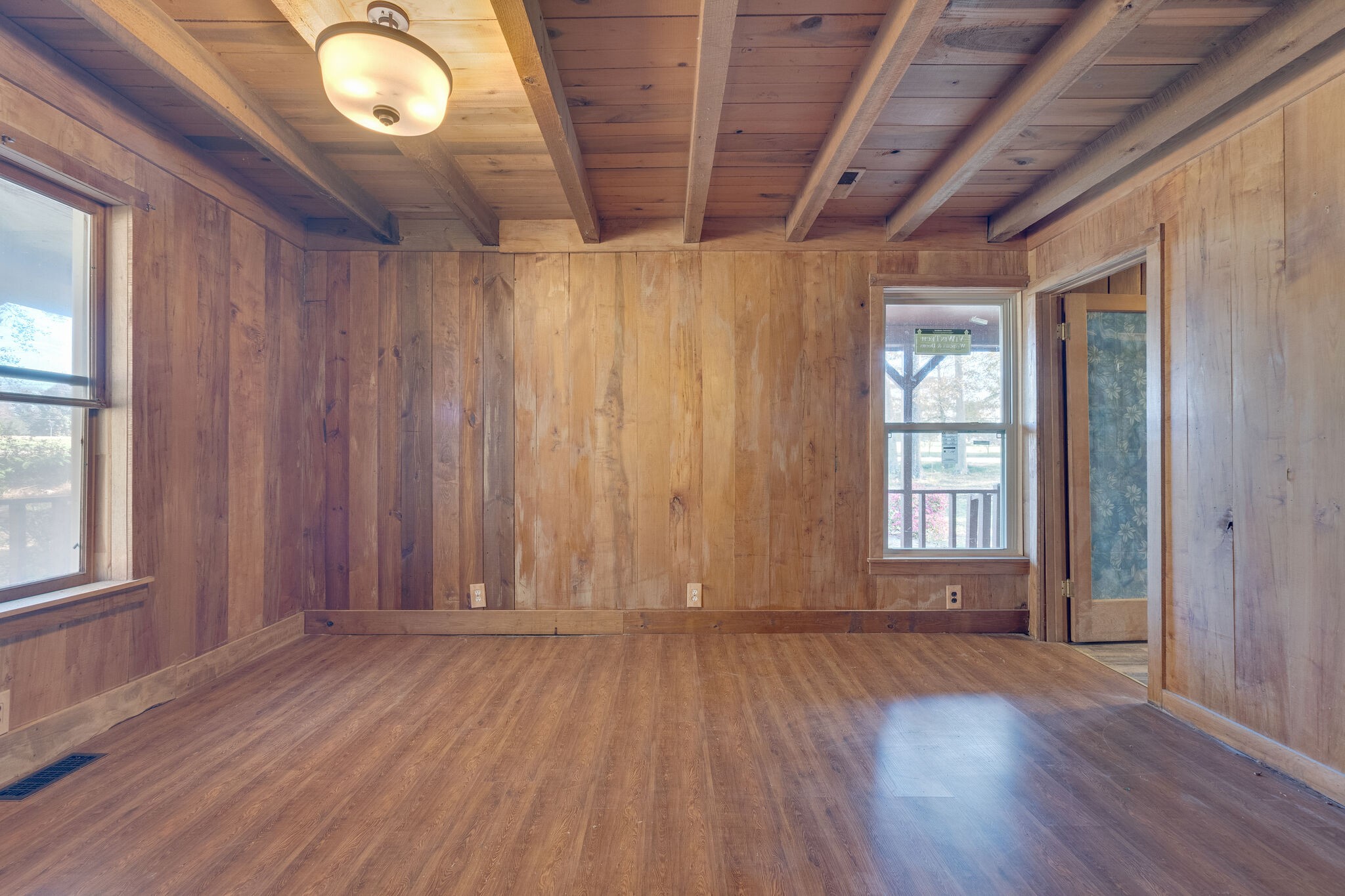 409 Elora Road Elora, TN 37328 - Photo 18 of 25 an empty room with wooden floor and windows