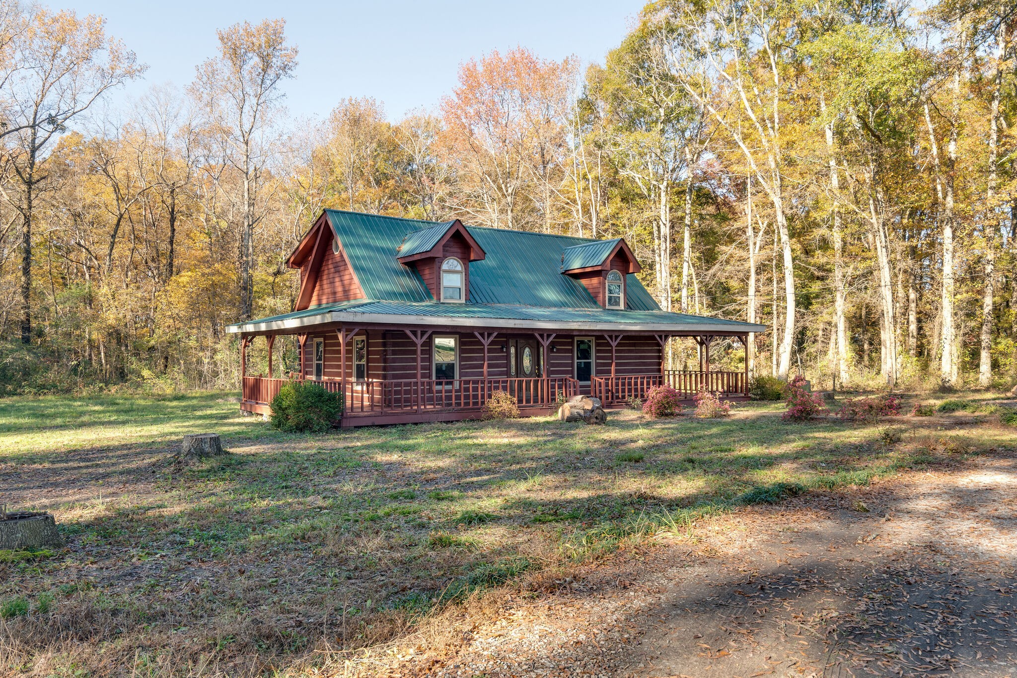 409 Elora Road Elora, TN 37328 - Photo 5 of 25 a view of a big house with a big yard plants and large trees