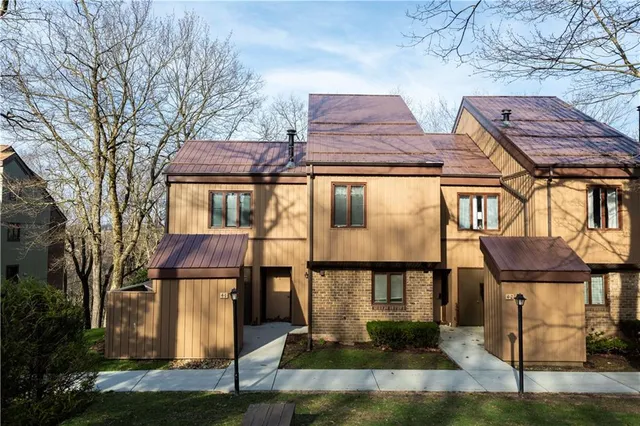 a front view of residential houses with yard