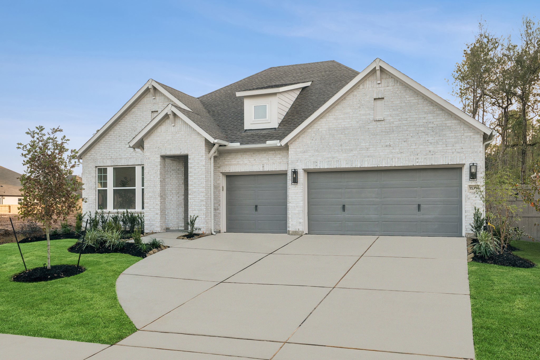 15714 Terracotta Terrace Lane Conroe, TX 77302 - Photo 3 of 47 a front view of a house with yard and green space