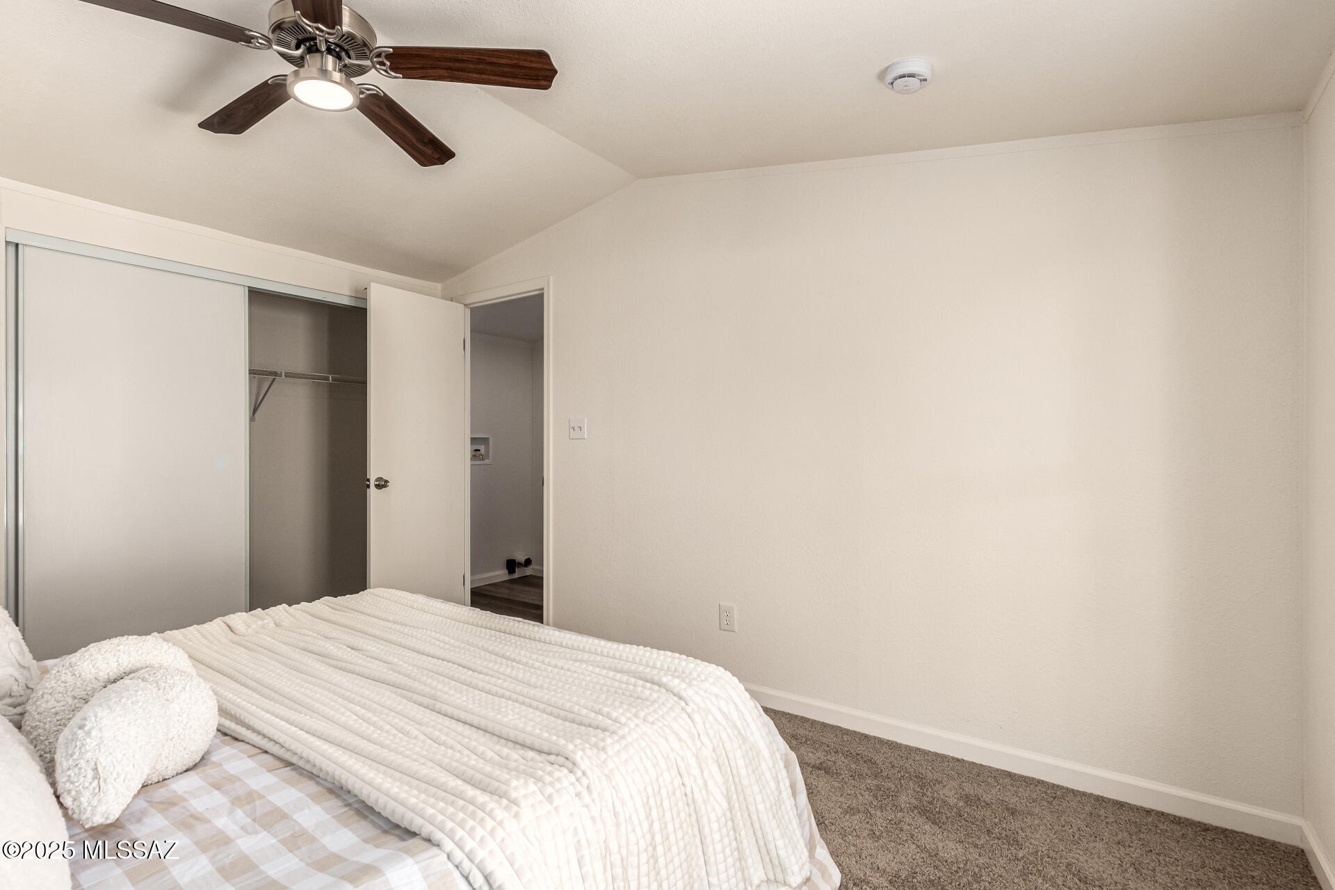 8401 South Kolb Road, Unit 94 Tucson, AZ 85756 - Photo 21 of 24 a bedroom with a bed and a chandelier