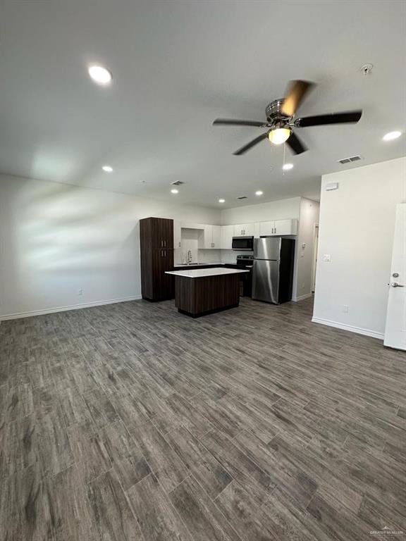 302 Sylvia Handy Drive, Unit B2 Elsa, TX 78543 - Photo 2 of 6 a view of a big room with wooden floor and windows
