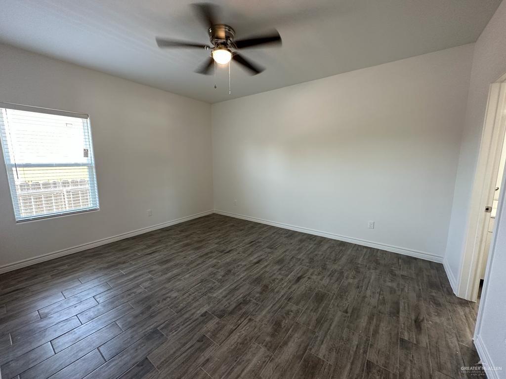 302 Sylvia Handy Drive, Unit B2 Elsa, TX 78543 - Photo 4 of 6 a view of empty room with wooden floor and fan