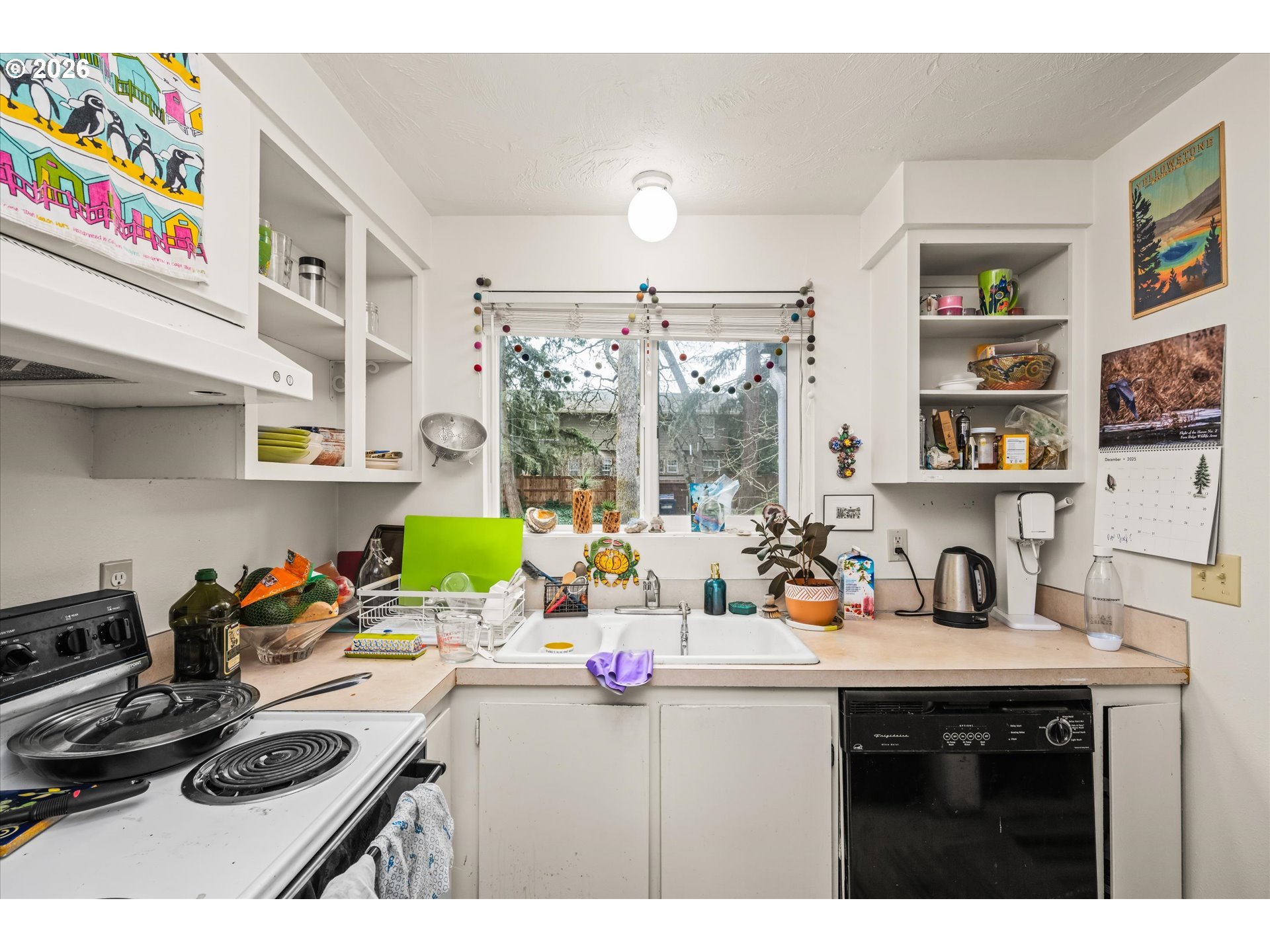 2145 Hawkins Lane Eugene, OR 97405 - Photo 11 of 38 a kitchen with a sink a stove and a wooden floor