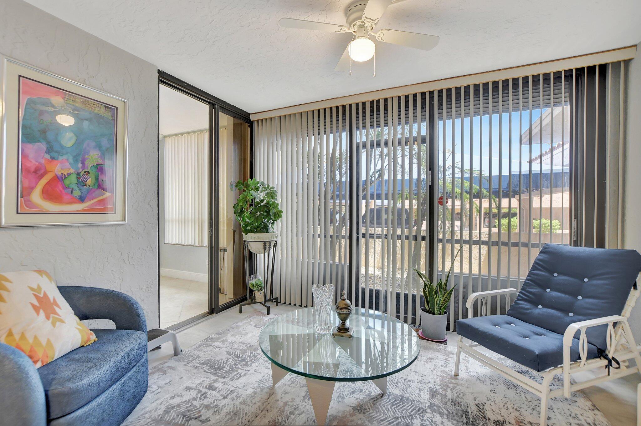 7194 Promenade Drive, Unit 102 Boca Raton, FL 33433 - Photo 11 of 56 a living room with furniture and a potted plant