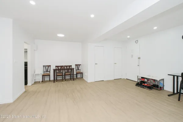a livingroom with a chair and a ceiling fan