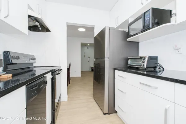 a kitchen with stainless steel appliances a refrigerator and a stove