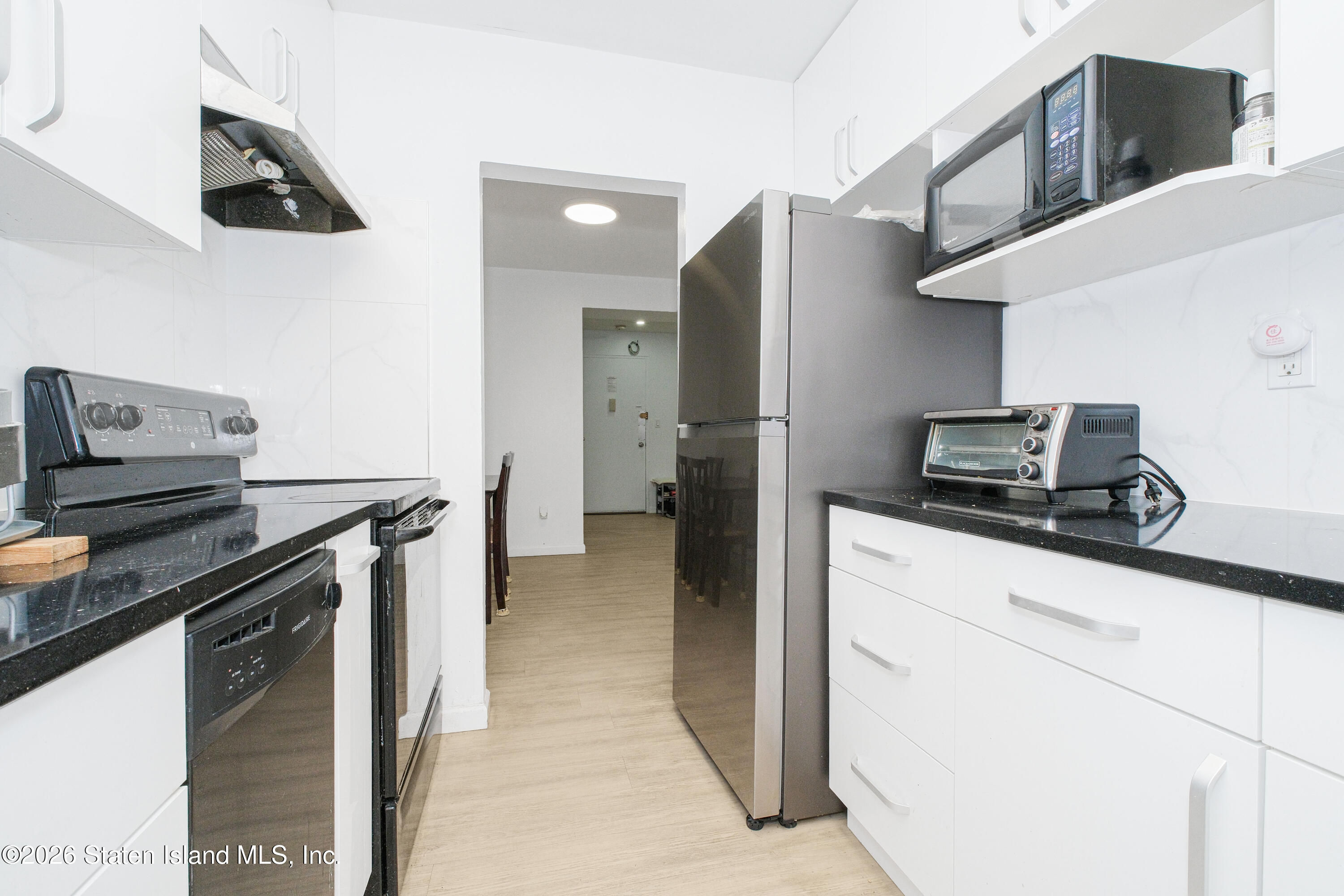 1160 Richmond Road, Unit 4G Staten Island, NY 10304 - Photo 7 of 14 a kitchen with stainless steel appliances a refrigerator and a stove