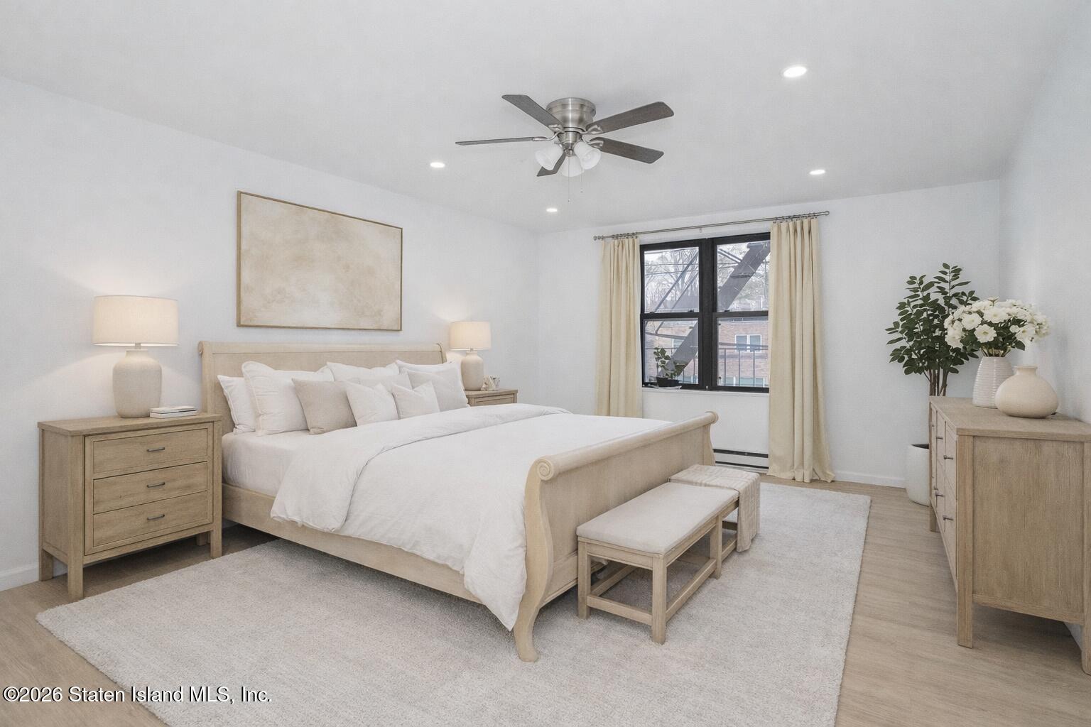1160 Richmond Road, Unit 4G Staten Island, NY 10304 - Photo 9 of 14 a spacious bedroom with a bed and a potted plant