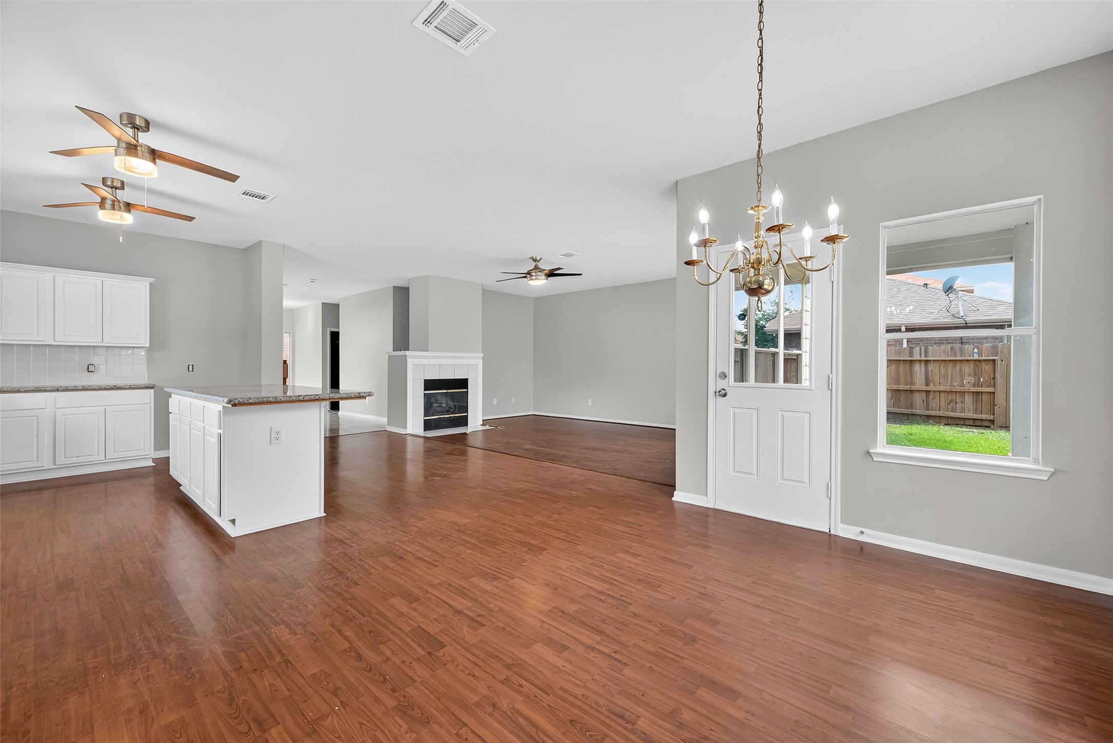 1302 Cross Draw Drive Houston, TX 77067 - Photo 10 of 35 a view of an empty room and kitchen with wooden floor