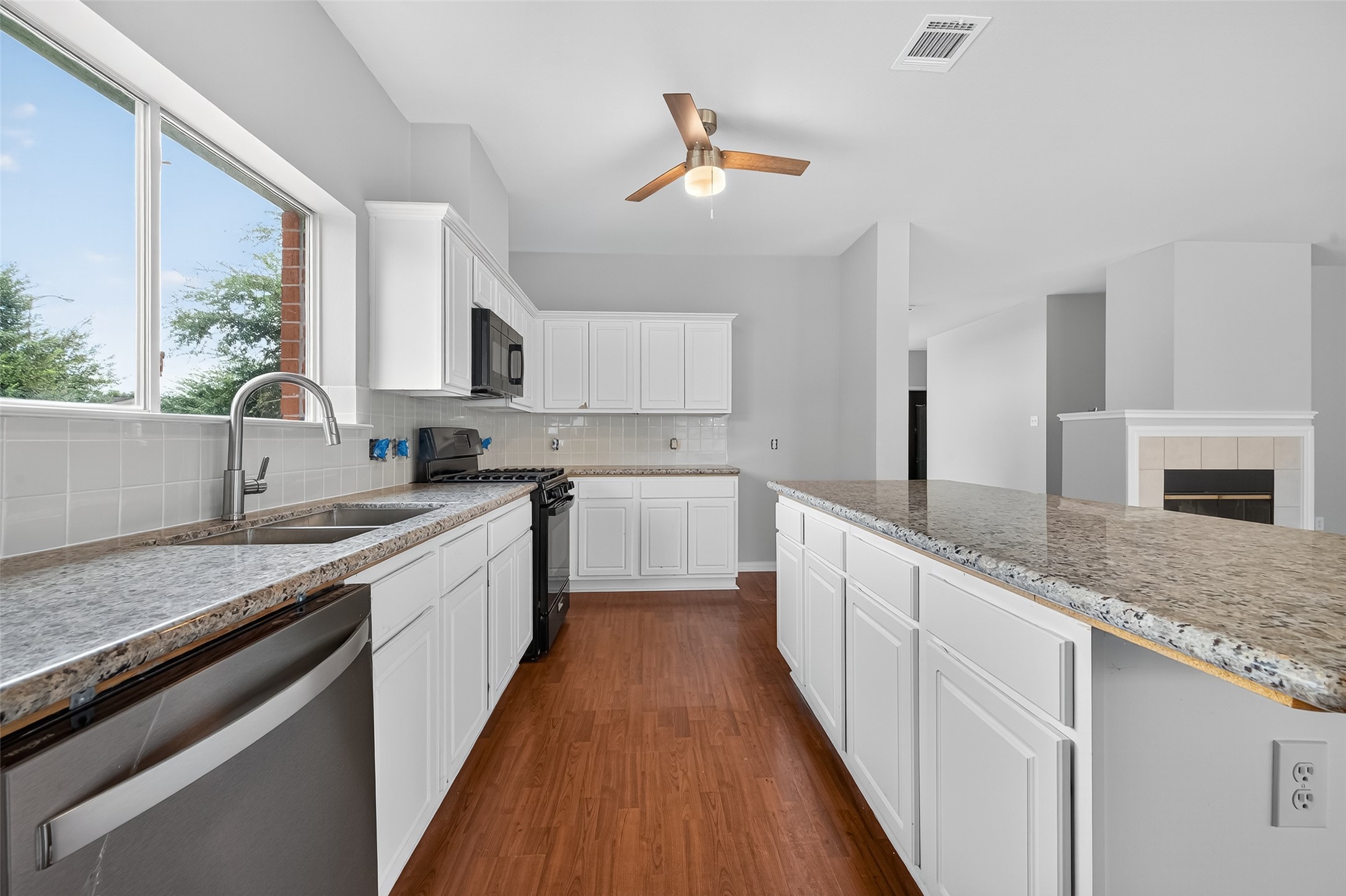 1302 Cross Draw Drive Houston, TX 77067 - Photo 12 of 35 a large kitchen with a lot of counter space and wooden floor